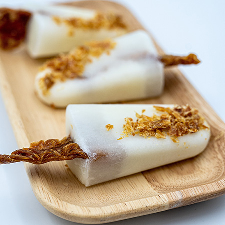 Man sieht ein selbstgemachtes Es aus Ziegenmilch und den WOW DOG Hühnerfilets